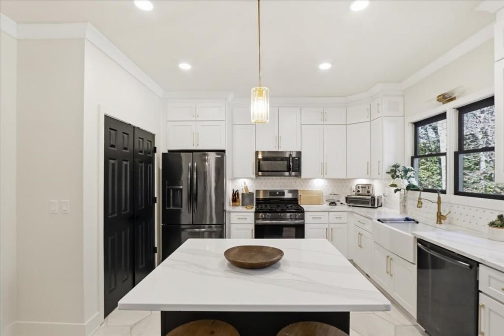 3222 Green Farm Trail Dacula, GA 30019 - Photo 23 of 92 a kitchen with stainless steel appliances a stove refrigerator sink and microwave