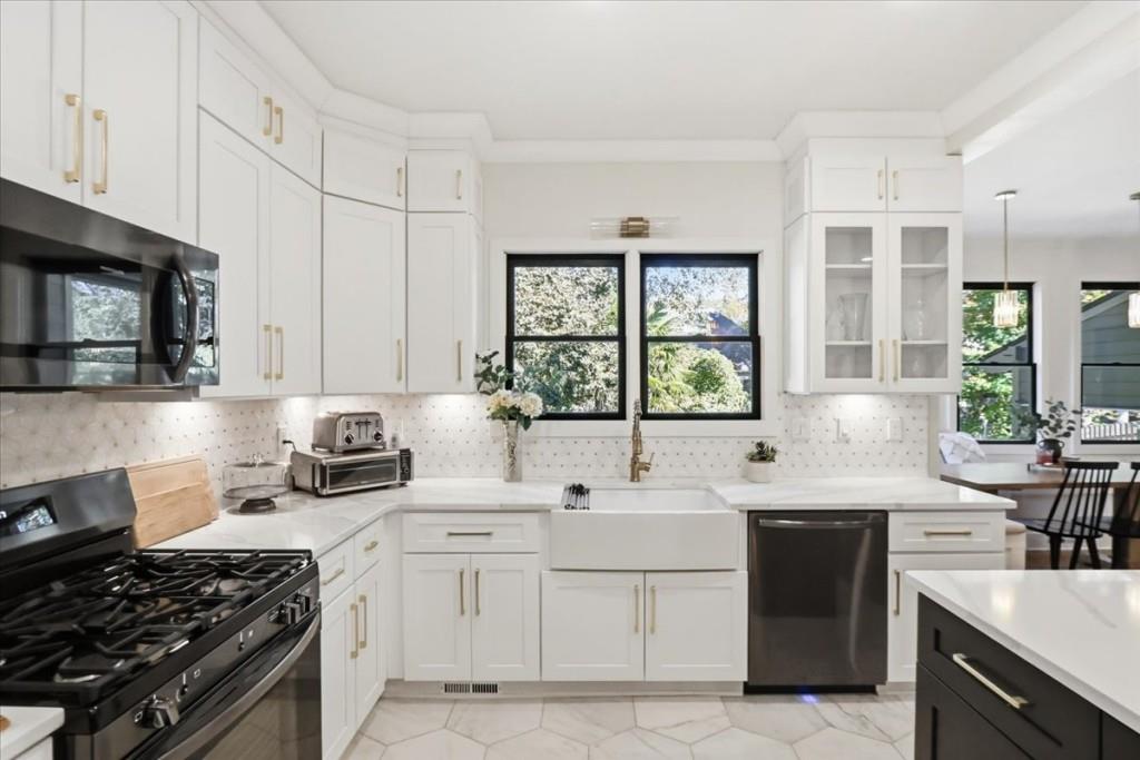 3222 Green Farm Trail Dacula, GA 30019 - Photo 26 of 92 a kitchen with stainless steel appliances a sink stove and cabinets