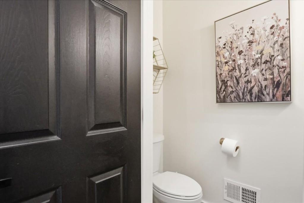 3222 Green Farm Trail Dacula, GA 30019 - Photo 32 of 92 a bathroom with a toilet and a shower curtain