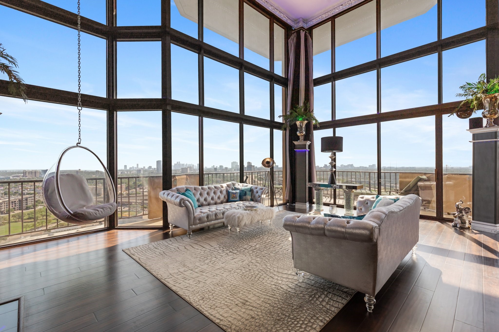 a living room with furniture and a floor to ceiling window