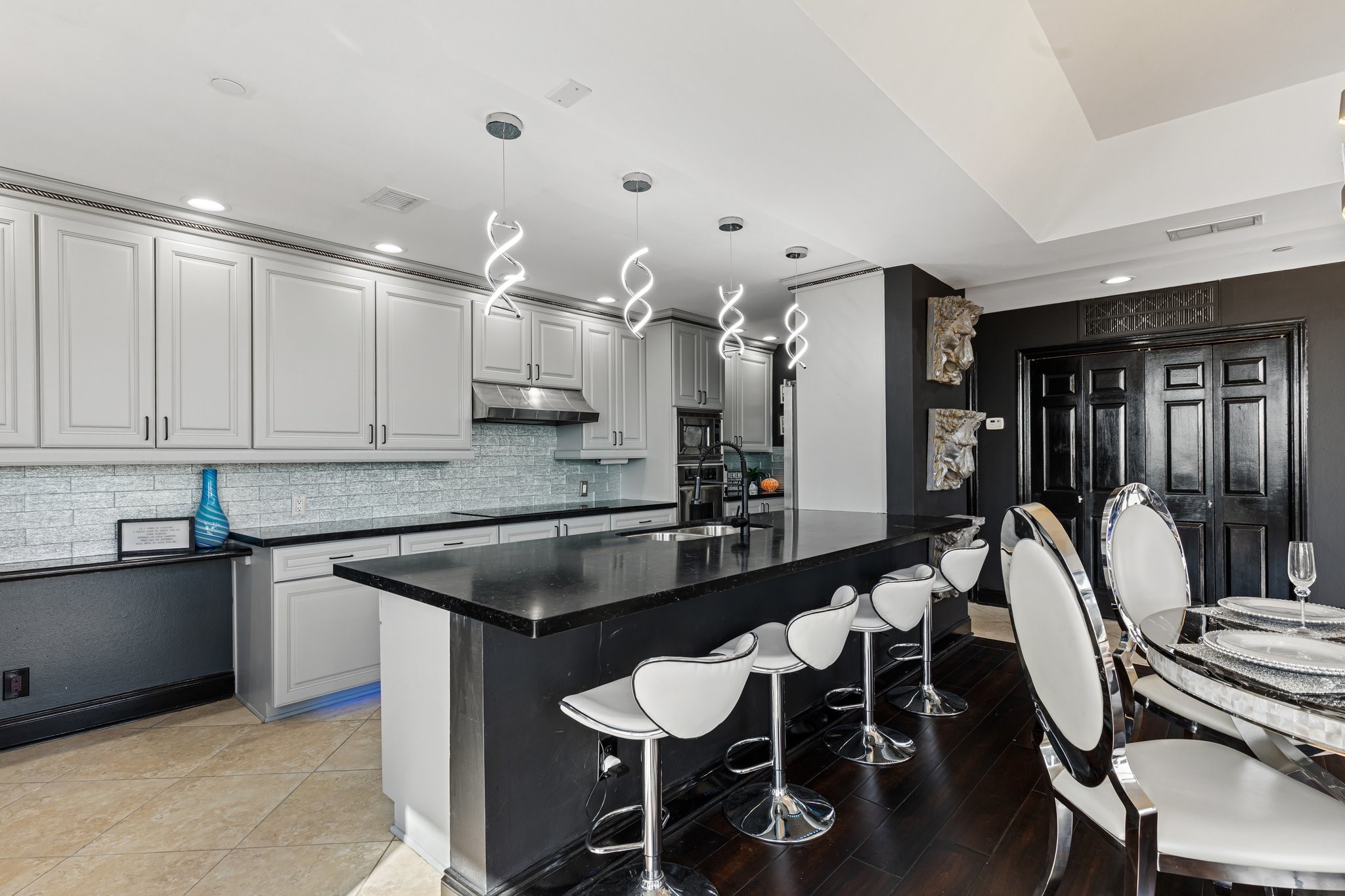 3350 McCue Road, Unit 2404 Houston, TX 77056 - Photo 16 of 49 a kitchen with a table chairs sink and cabinets