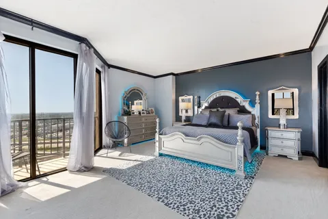 a bedroom with a large bed and a window