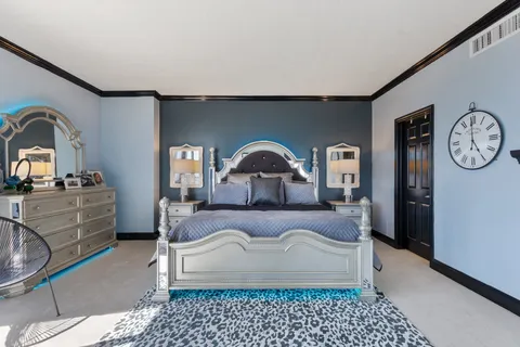 a bedroom with a bed and a dresser