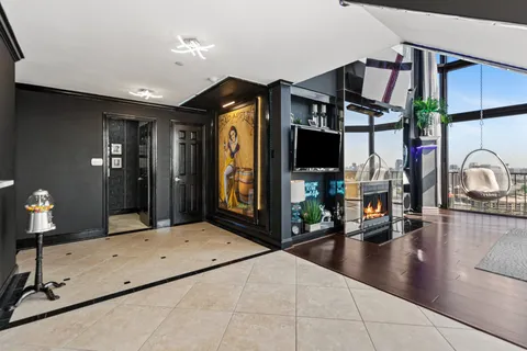 a lobby with a couch and a flat screen tv