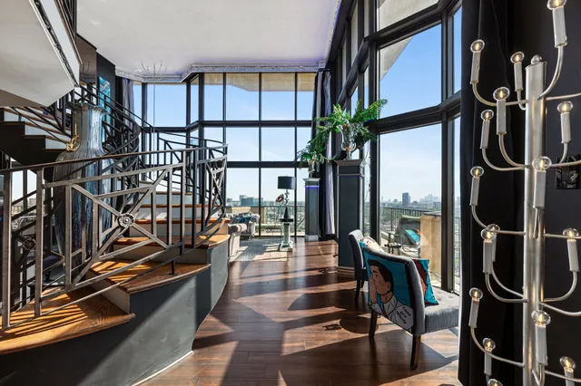 a very nice looking dining room with furniture window and wooden floor