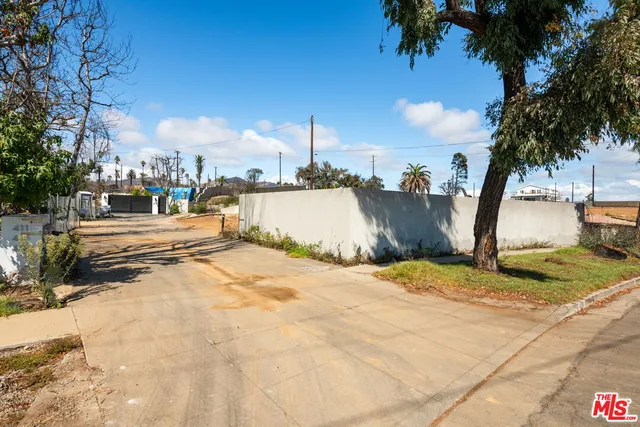 a view of a swimming pool with a lawn chairs and a fire pit