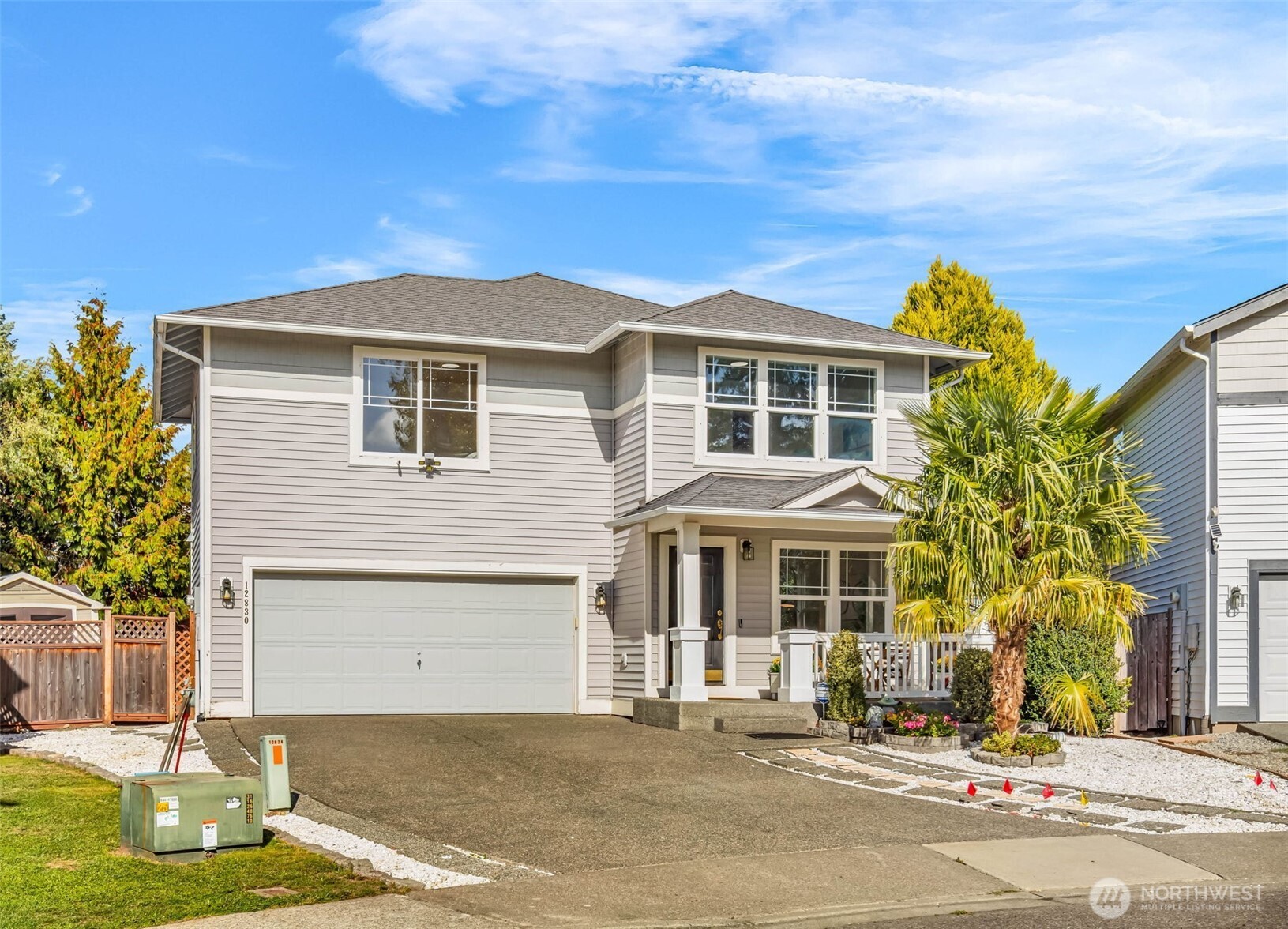 a front view of a house with a garden