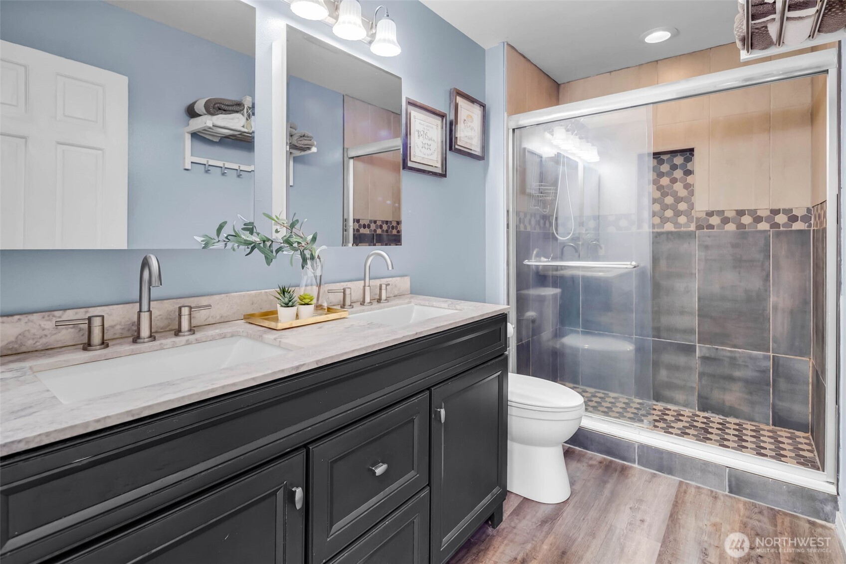 12830 Southeast 299th Street Auburn, WA 98092 - Photo 15 of 30 a bathroom with a granite countertop sink a toilet a mirror and shower