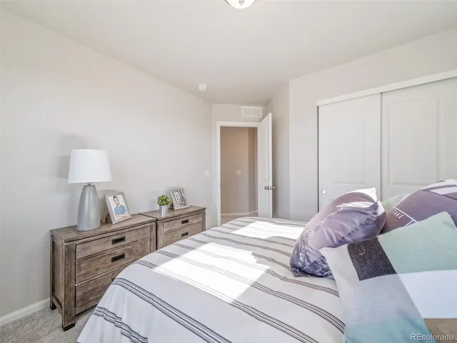 a bedroom with a bed and a lamp on table