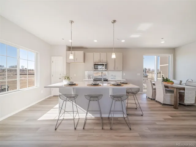 a kitchen with a table and chairs in it