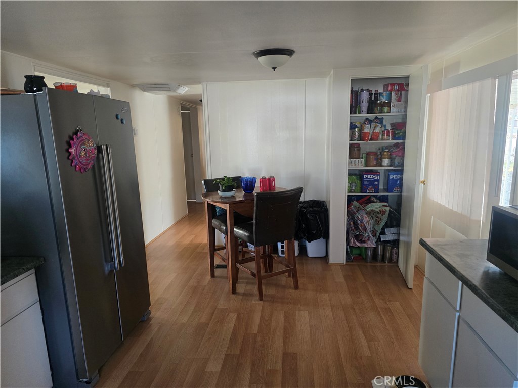 15252 Seneca Road, Unit 7 Victorville, CA 92392 - Photo 10 of 20 a view of a dining room with furniture and wooden floor