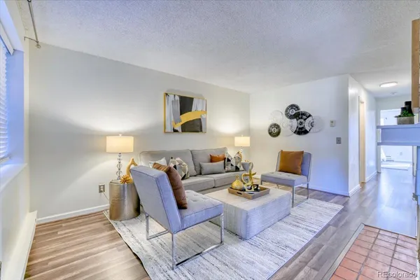 a living room with furniture and wooden floor