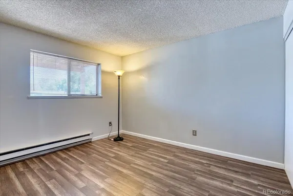 a view of a room with wooden floor and windows