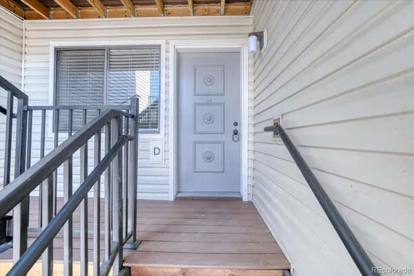 a view of a balcony with wooden floor and stairs