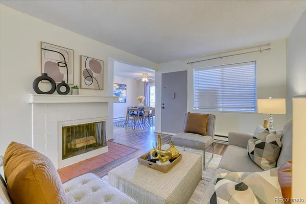 a living room with furniture and a fireplace