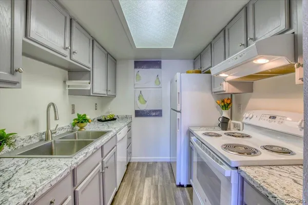 a kitchen with a sink stove and refrigerator