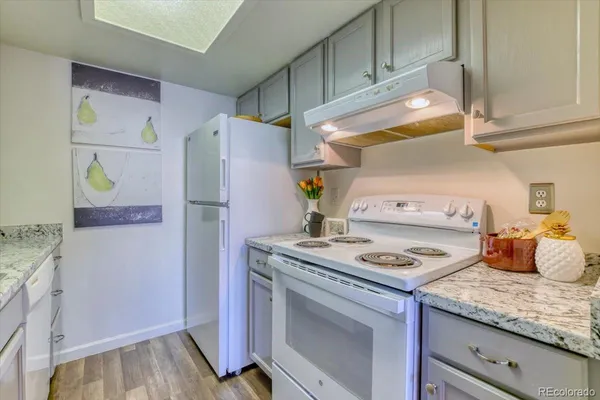 a kitchen with stainless steel appliances granite countertop a refrigerator and a stove