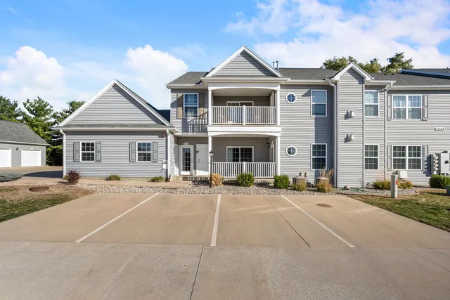 a front view of a house with yard and trees
