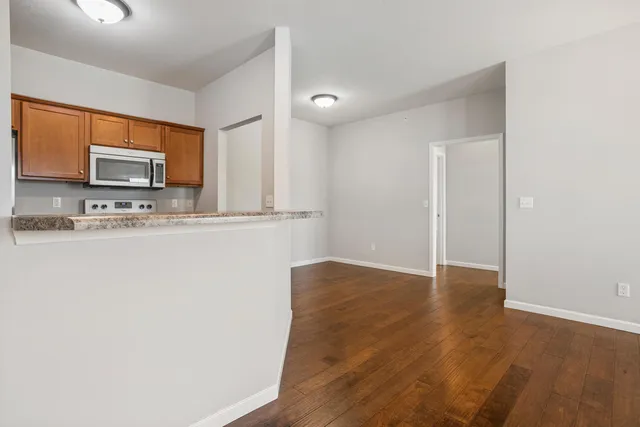 a kitchen with stainless steel appliances a microwave a sink and a refrigerator