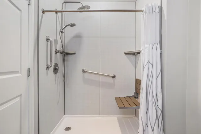 a bathroom with a shower and a shower