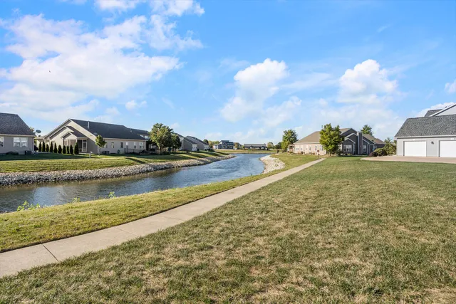 a view of a lake with houses in the back