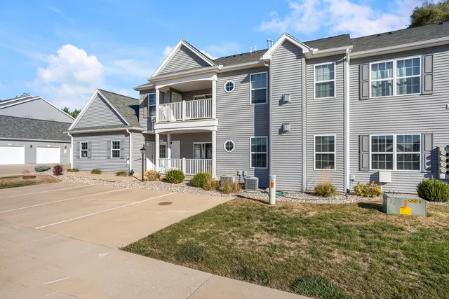 a front view of a house with a yard and seating space