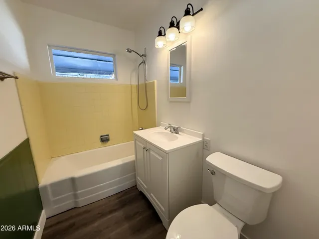 a bathroom with a sink a toilet and bathtub