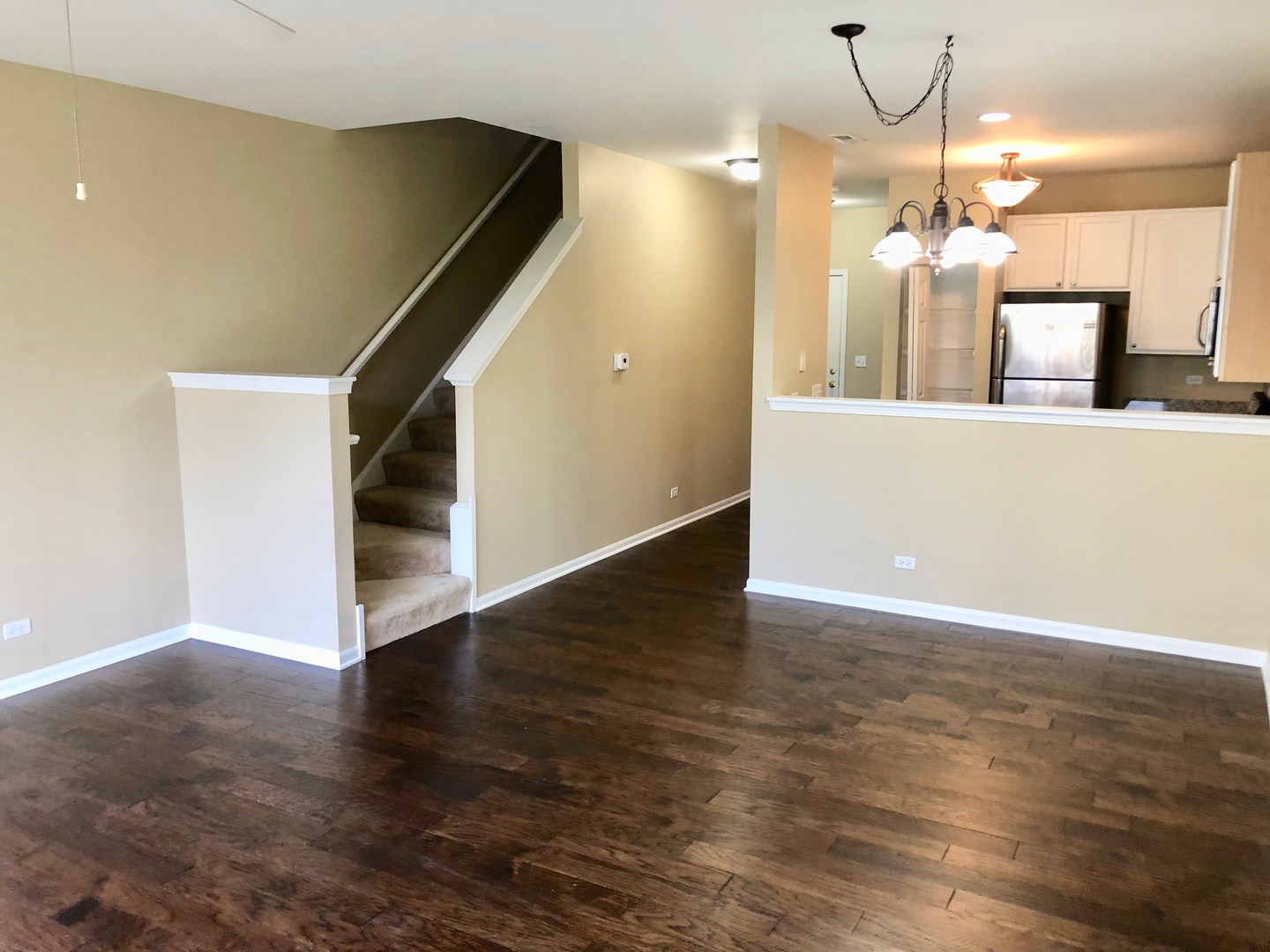 3072 Falling Waters Lane Lindenhurst, IL 60046 - Photo 5 of 27 a view of a kitchen with a chandelier and wooden floor