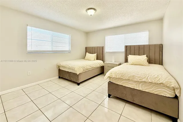 a bedroom with double bed and a window