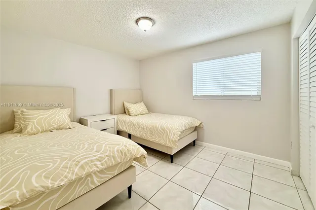 a bedroom with two beds and a window