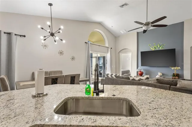 a bathroom with a granite countertop sink a large mirror and vanity