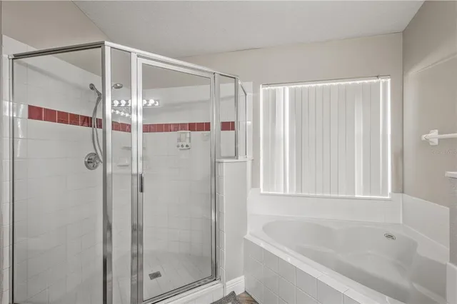 a bathroom with a bathtub and a shower
