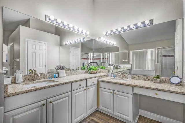 a bathroom with a double vanity sink and a mirror
