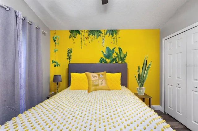 a bedroom with a bed and wall painting