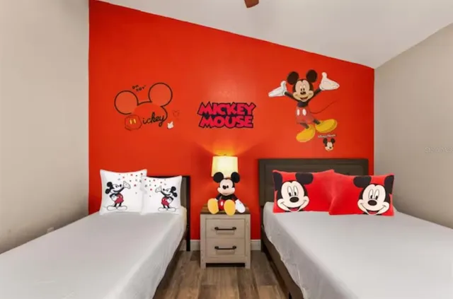 a bedroom with a bed and a painting on the wall