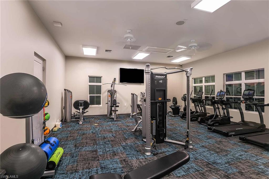 4676 Arboretum Circle, Unit 102 Naples, FL 34112 - Photo 11 of 35 a gym room with lots of gym equipment