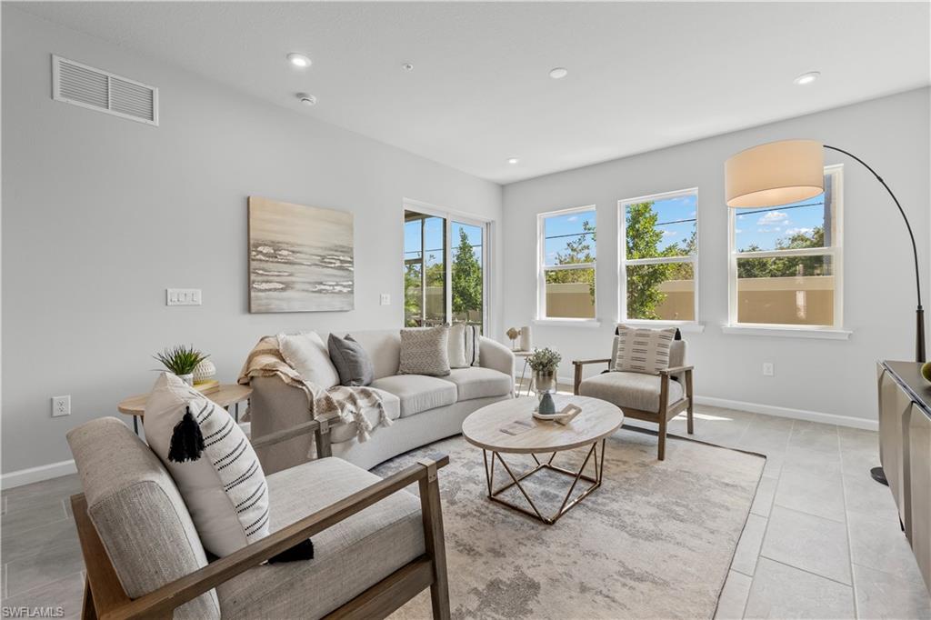 4676 Arboretum Circle, Unit 102 Naples, FL 34112 - Photo 21 of 35 a living room with furniture and a window