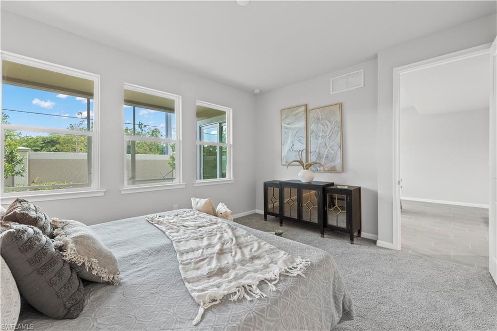 4676 Arboretum Circle, Unit 102 Naples, FL 34112 - Photo 26 of 35 a bedroom with a bed and a couch