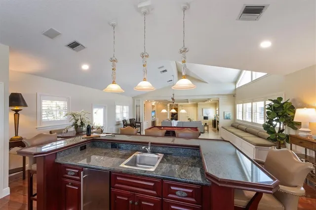 a large kitchen with stainless steel appliances granite countertop a sink and cabinets
