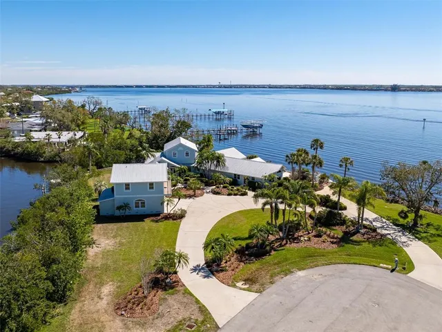 an aerial view of a house with a lake view