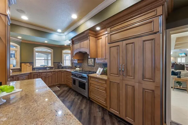 a bedroom with a bed couch and large window