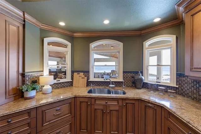 a spacious bathroom with a granite countertop sink and a mirror