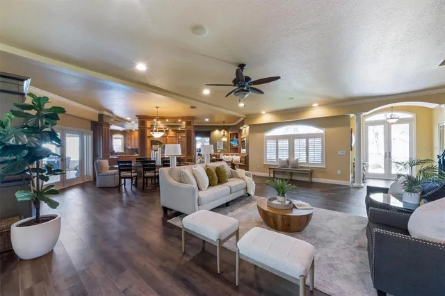 a living room with furniture and wooden floor
