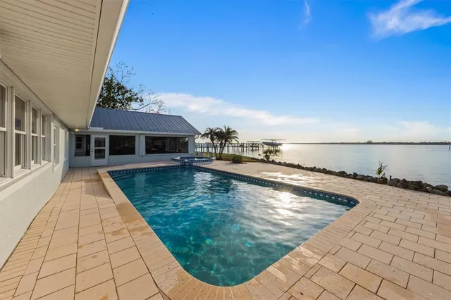 a living room with furniture a air conditioner vent and a large window