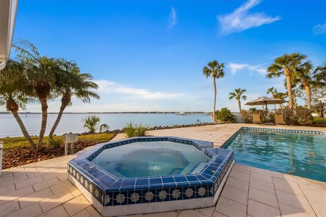 a living room with furniture a table and a chandelier