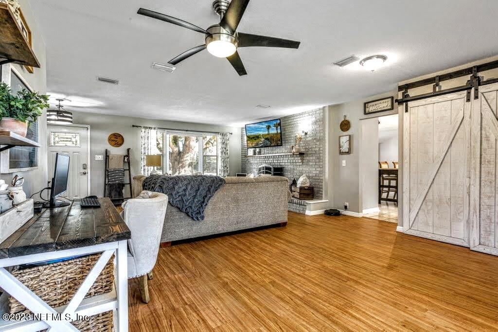 4233 Oak Lane St. Augustine, FL 32086 - Photo 1 of 40 a living room with furniture and a wooden floor
