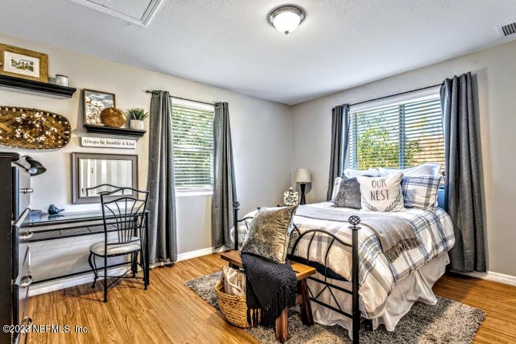 4233 Oak Lane St. Augustine, FL 32086 - Photo 23 of 40 a bedroom with a bed and wooden floor