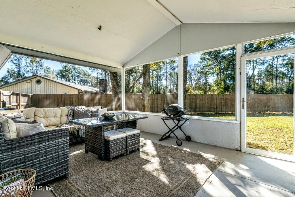 4233 Oak Lane St. Augustine, FL 32086 - Photo 31 of 40 a living room with furniture and a large window