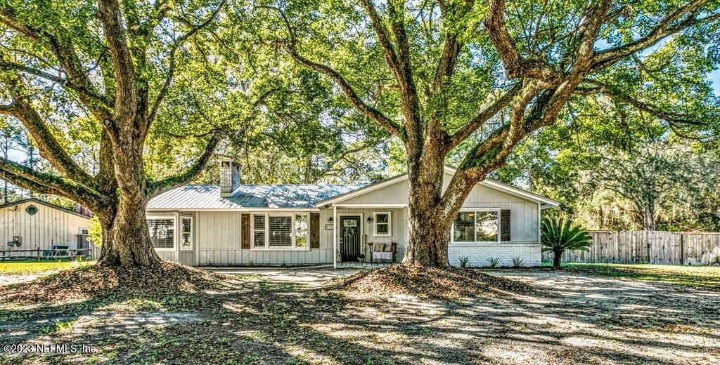 4233 Oak Lane St. Augustine, FL 32086 - Photo 6 of 40 a view of a yard in front of a house with large trees