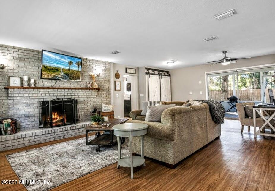 4233 Oak Lane St. Augustine, FL 32086 - Photo 8 of 40 a living room with furniture and a fireplace